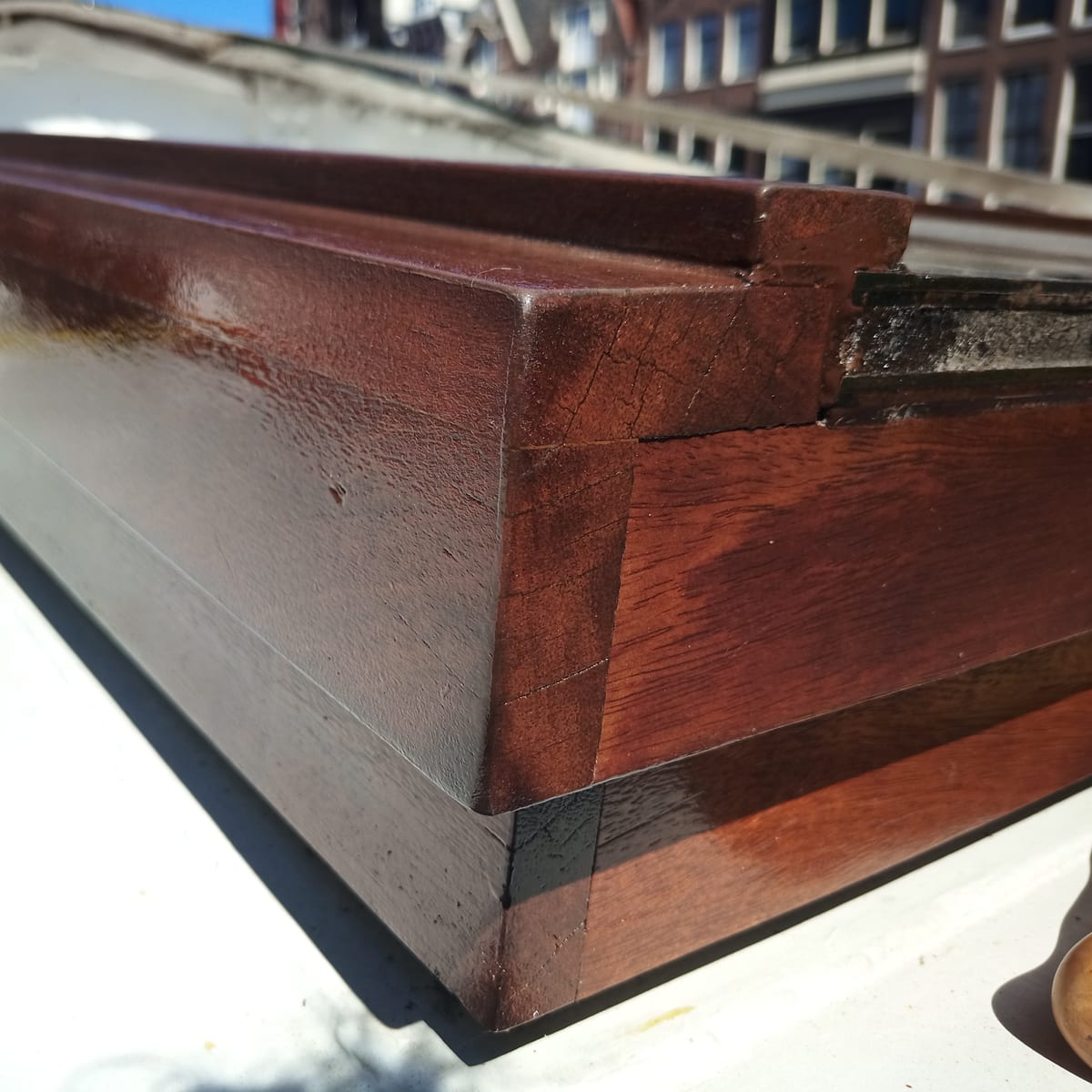 Close view of a hand-finished hardwood coaming joint on the restored boat deck