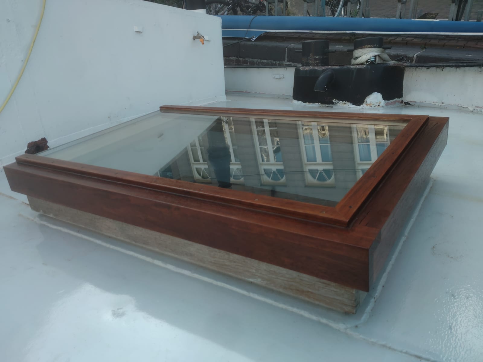 Custom timber rooflight on the boat deck with Amsterdam houses reflected in the glass